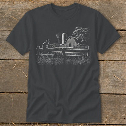 Dark t-shirt with a white sketched farm scene featuring a cat on a fence.