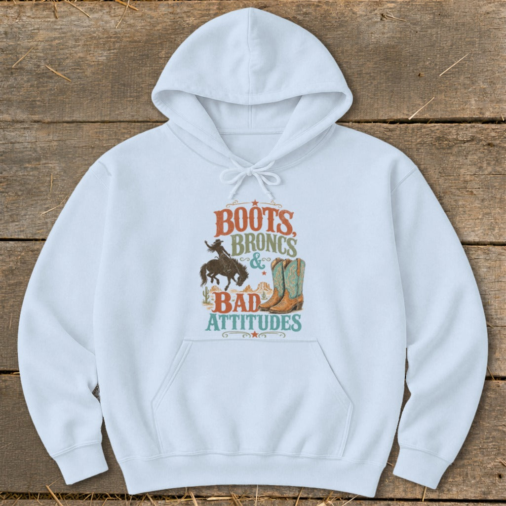 White hoodie with "Boots Broncs & Bad Attitudes" graphic featuring a cowboy and boots.