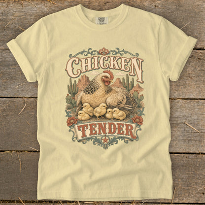 T-shirt graphic with hen and chicks in desert landscape, text "Chicken Tender".