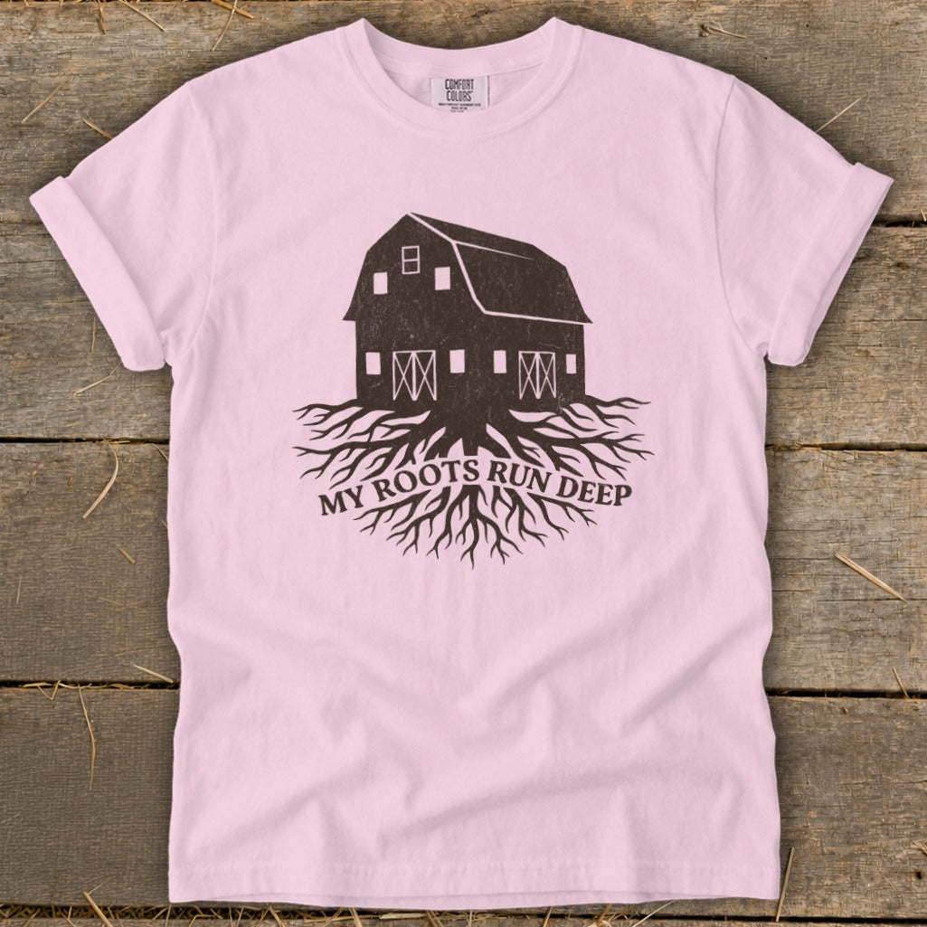 Pink t-shirt with barn and roots graphic, text reads "MY ROOTS RUN DEEP".
