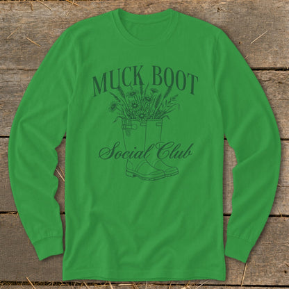 Green long-sleeve shirt with "Muck Boot Social Club" text and a drawing of boots with flowers.