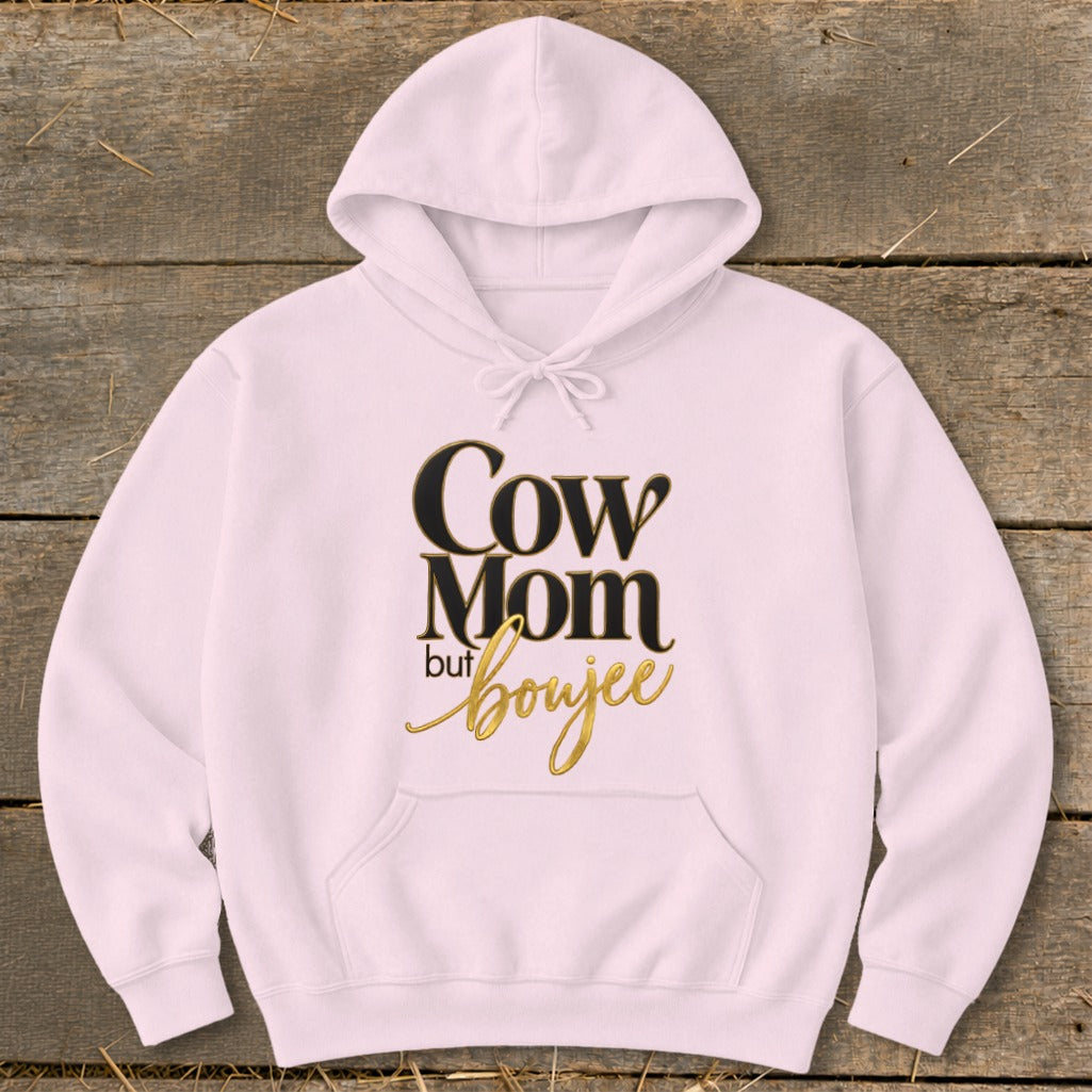 Pink hoodie with "Cow Mom but boujee" text in gold and black lettering.
