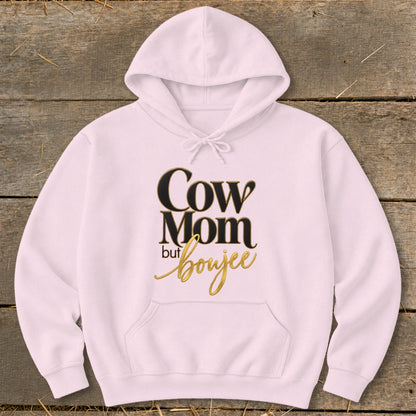 Pink hoodie with "Cow Mom but boujee" text in gold and black lettering.