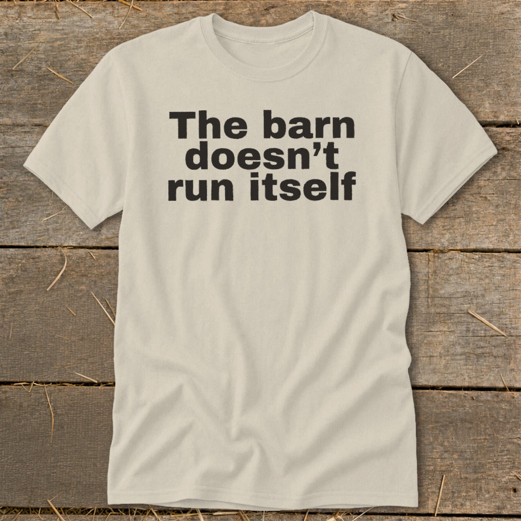 Light tan t-shirt with black text "The barn doesn't run itself."