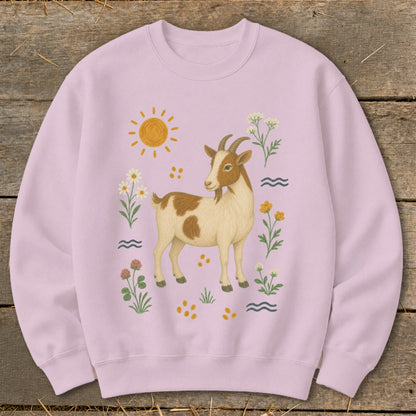 Pink sweatshirt with a watercolor illustration of a goat, sun, and flowers.