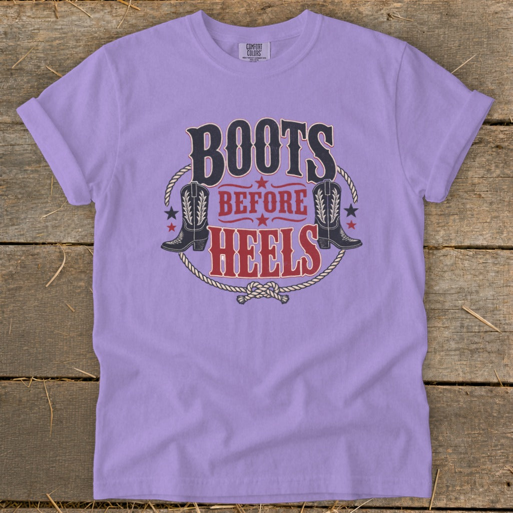 Lavender t-shirt with "Boots Before Heels" text, cowboy boots, and rope graphic.