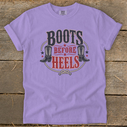 Lavender t-shirt with "Boots Before Heels" text, cowboy boots, and rope graphic.