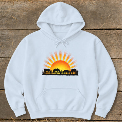 White hoodie with a graphic of horses grazing at sunset.