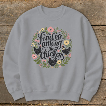Gray sweatshirt with floral wreath and text "Find me among the chickens".