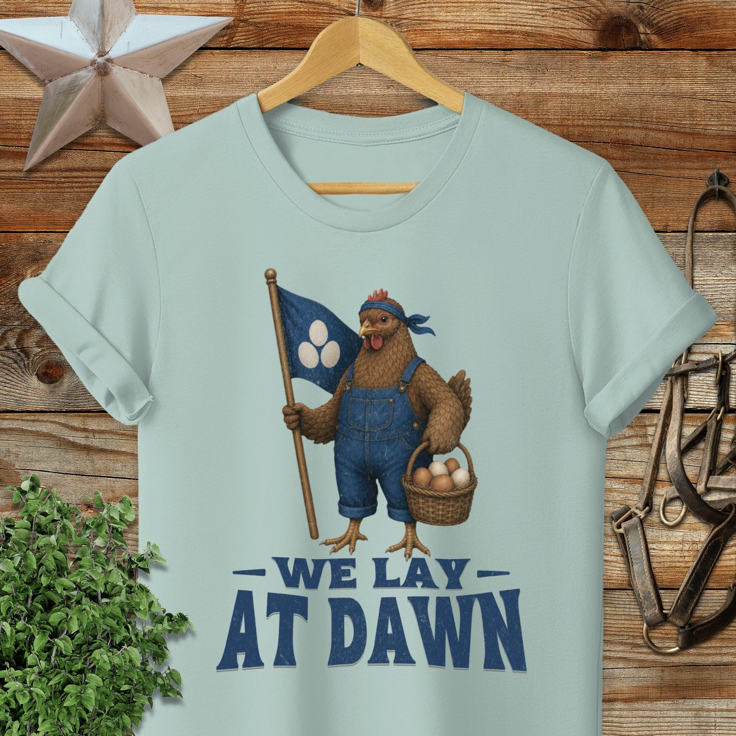 T-shirt with a chicken wearing overalls holding a basket and a flag.