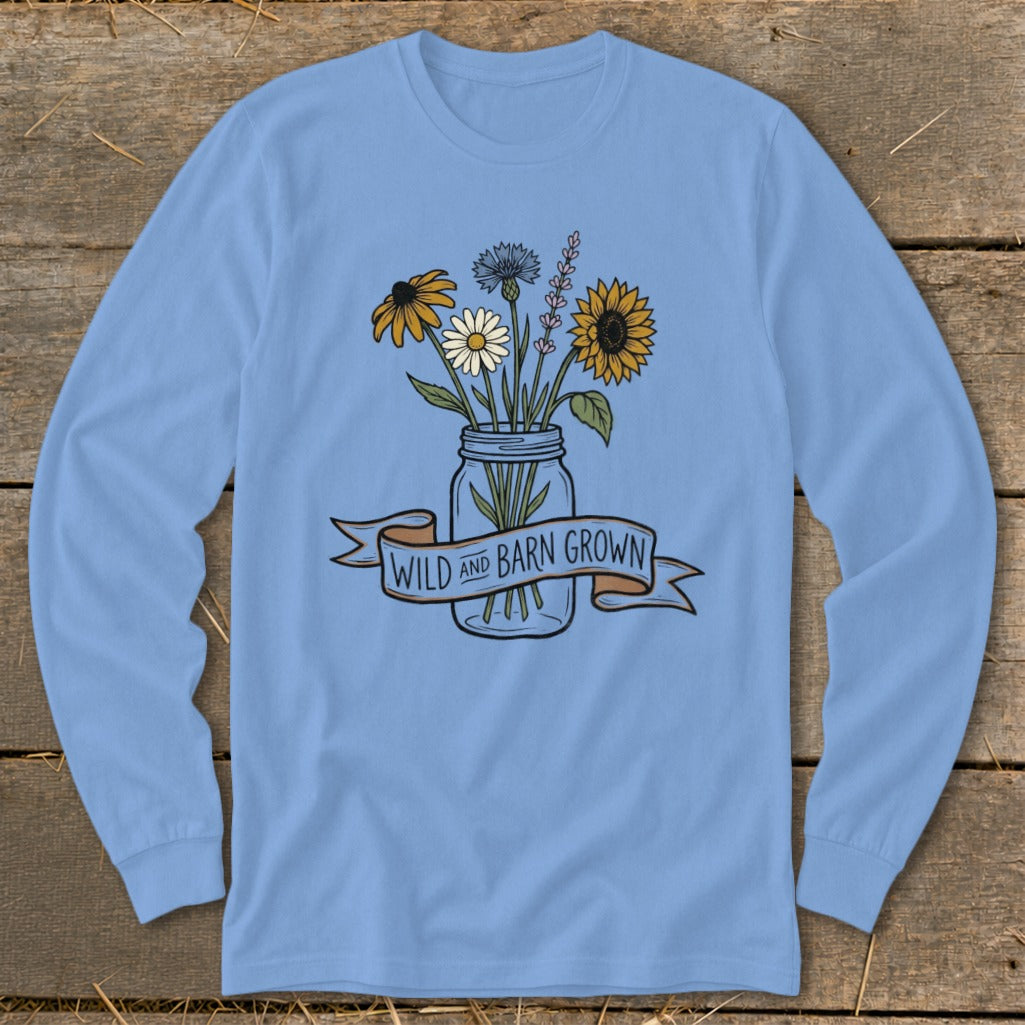 Light blue long-sleeve shirt with a mason jar of wildflowers and text that says "Wild and Barn Grown."
