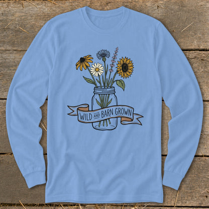 Light blue long-sleeve shirt with a mason jar of wildflowers and text that says "Wild and Barn Grown."