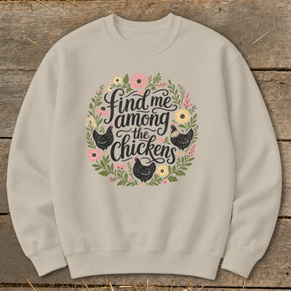Light tan crewneck sweatshirt with "Find me among the chickens" in floral wreath design.