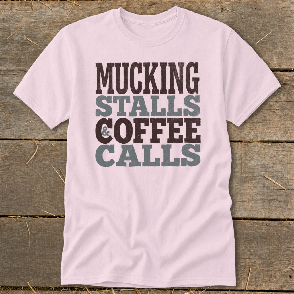 Pink t-shirt with "Mucking Stalls Coffee Calls" text design.