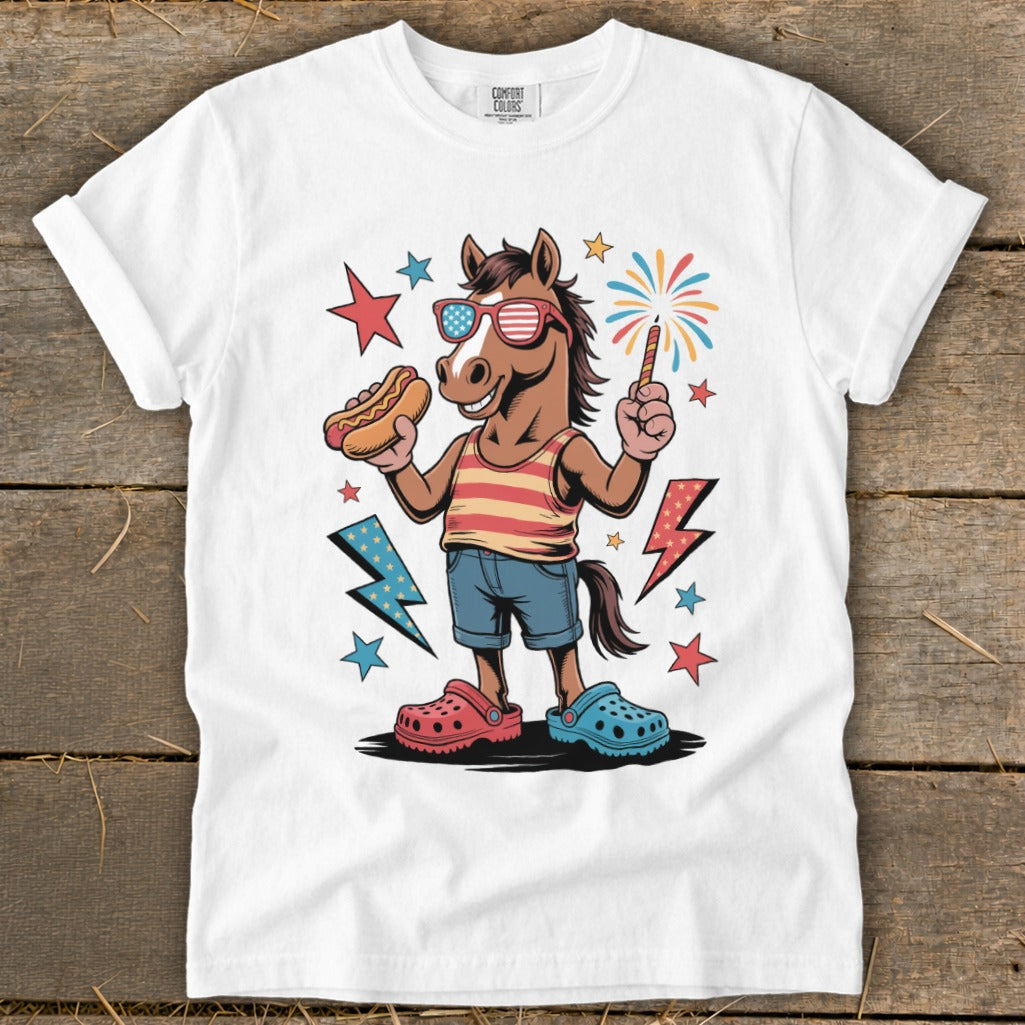 Cartoon horse in sunglasses holding hot dog and sparkler, wearing red striped tank top and denim shorts.