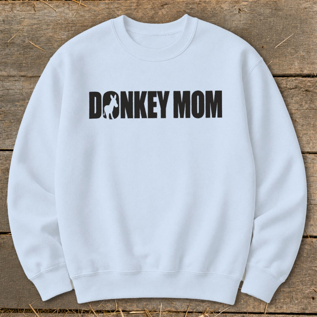Light blue crewneck sweatshirt with bold black text reading "DONKEY MOM" and a donkey silhouette.