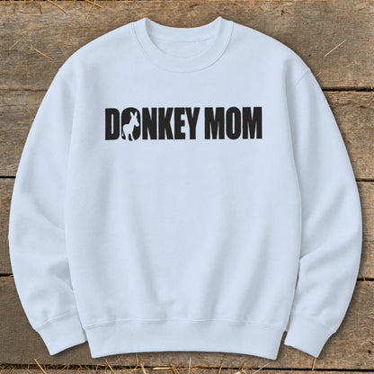 Light blue crewneck sweatshirt with bold black text reading "DONKEY MOM" and a donkey silhouette.