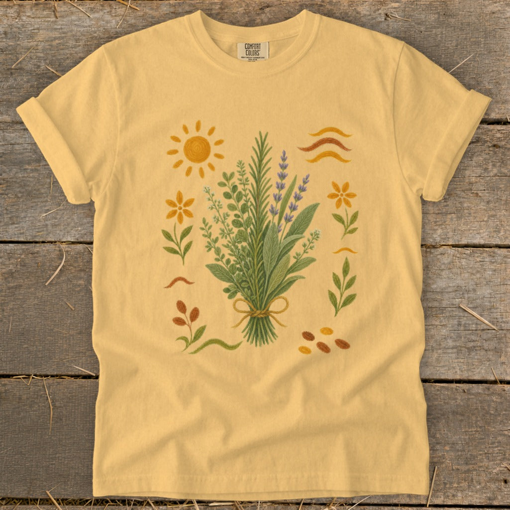Yellow t-shirt with a floral bouquet, sun, and wavy lines graphic.