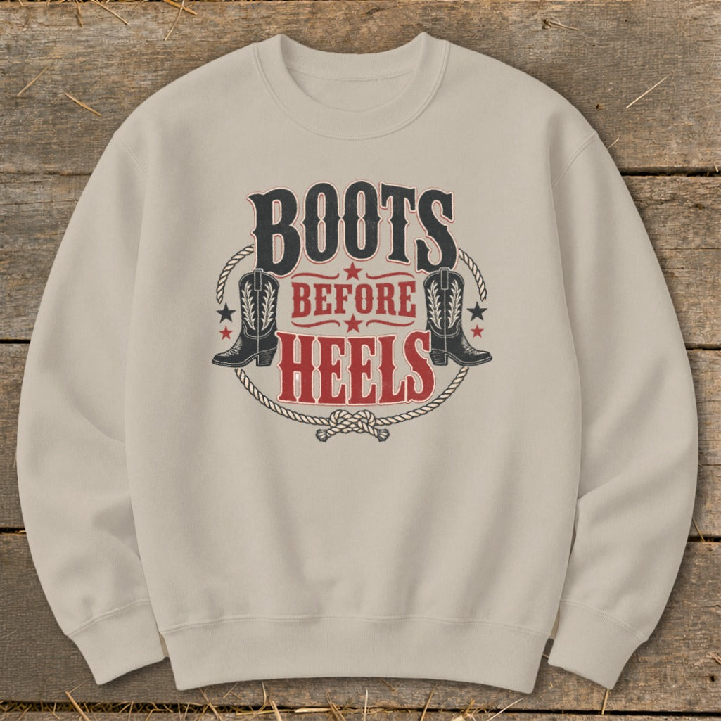 Tan sweatshirt with "Boots Before Heels" graphic featuring cowboy boots and rope.