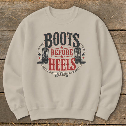 Tan sweatshirt with "Boots Before Heels" graphic featuring cowboy boots and rope.