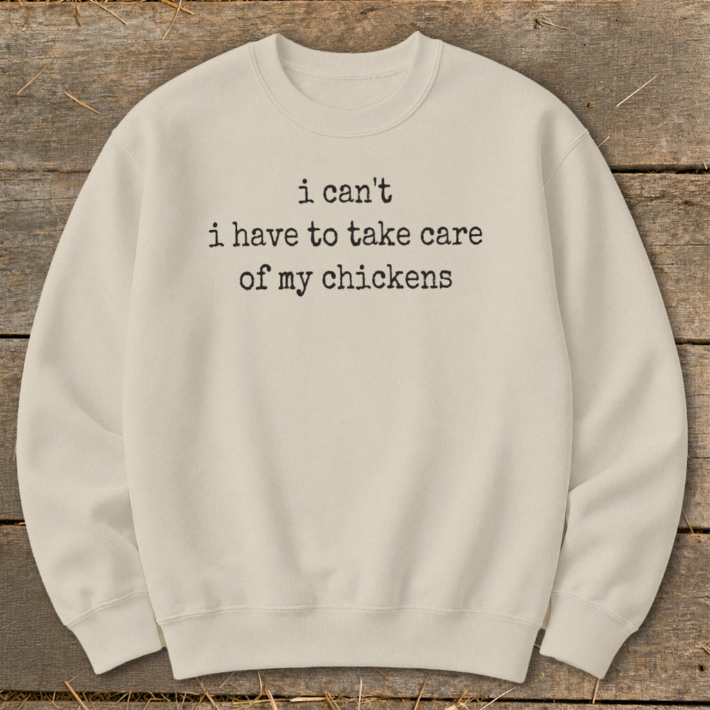 Cream sweatshirt with black text "i can't i have to take care of my chickens".