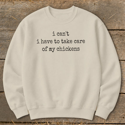 Cream sweatshirt with black text "i can't i have to take care of my chickens".