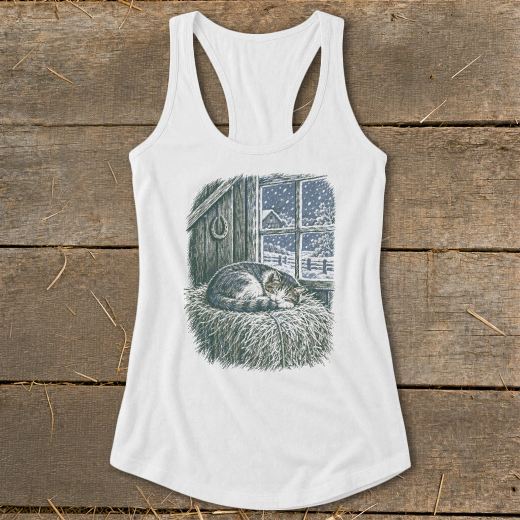 White tank top with a print of a sleeping cat on hay in front of a snowy barn window.
