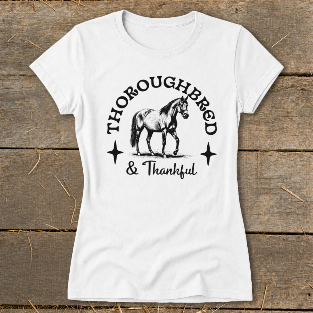 White t-shirt with a graphic of a horse and the text "Thoroughbred & Thankful".