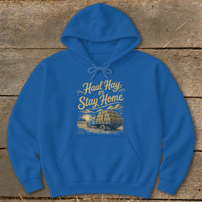 Blue hoodie with yellow text "Haul Hay or Stay Home" over a truck with hay bales.