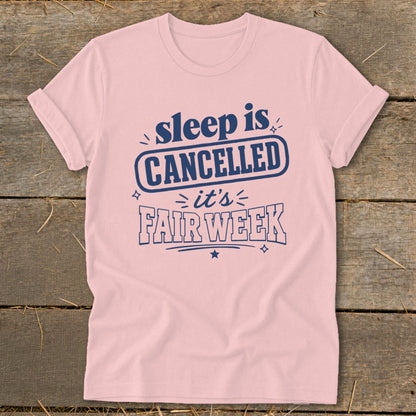 Pink t-shirt with blue text reading "sleep is CANCELLED it's FAIR WEEK".