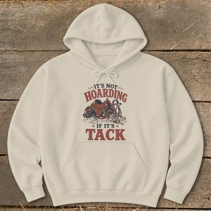 Cream hoodie with "It's Not Hoarding If It's Tack" text and equestrian tack graphic.