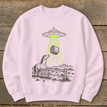 UFO abducting a bale of hay over a horse and fence in a rural landscape.