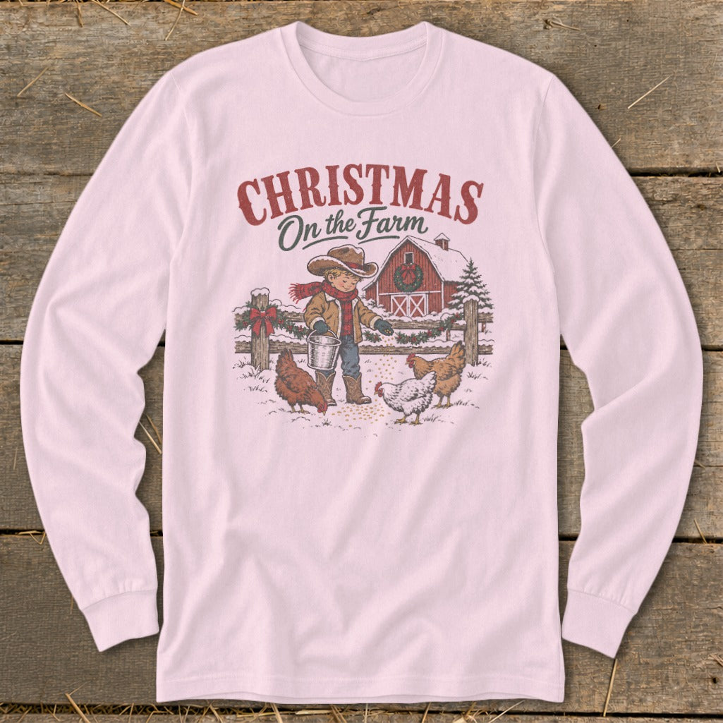 Long sleeve shirt with a Christmas farm scene graphic featuring a child feeding chickens.