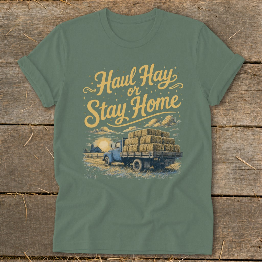 Green t-shirt with "Haul Hay or Stay Home" text and illustration of a blue truck hauling hay.