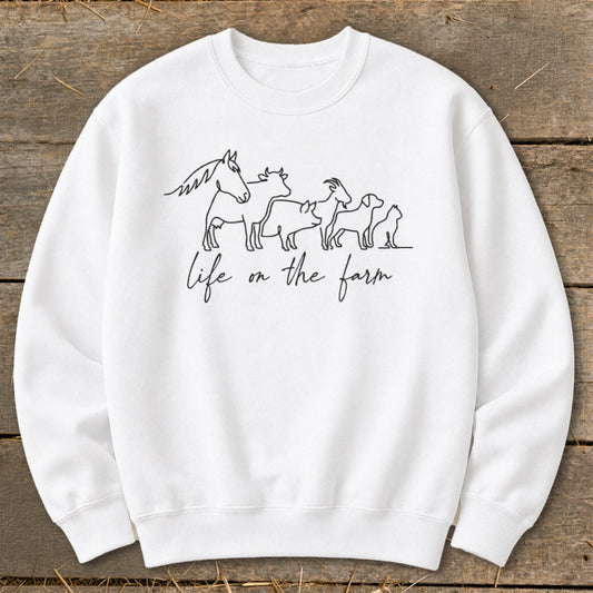 White sweatshirt with black line art of farm animals and "life on the farm" text.