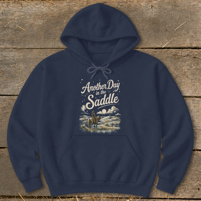 Navy hoodie with "Another Day in the Saddle" graphic and horse rider illustration.
