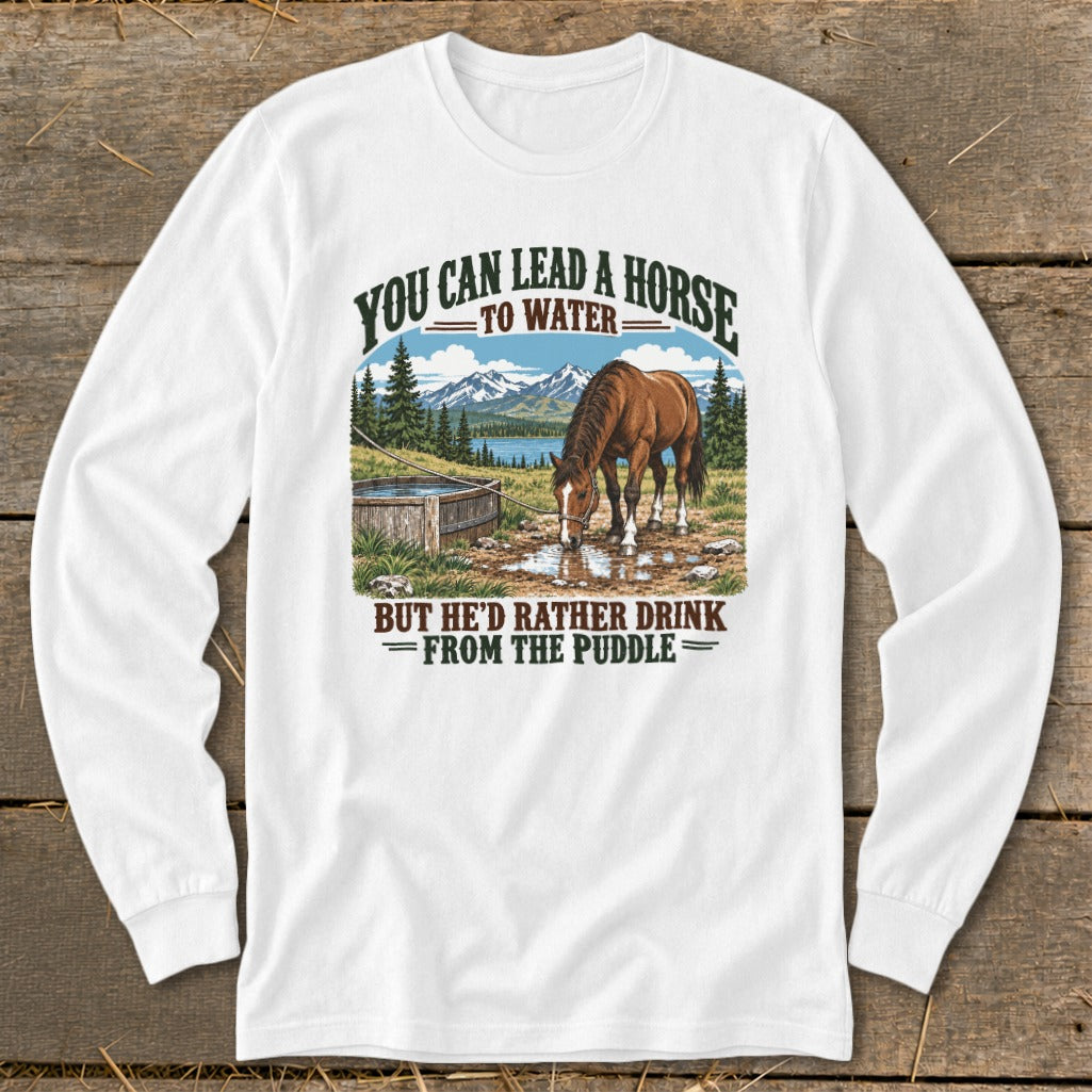White long-sleeve t-shirt featuring a horse drinking from a puddle graphic with humorous text.