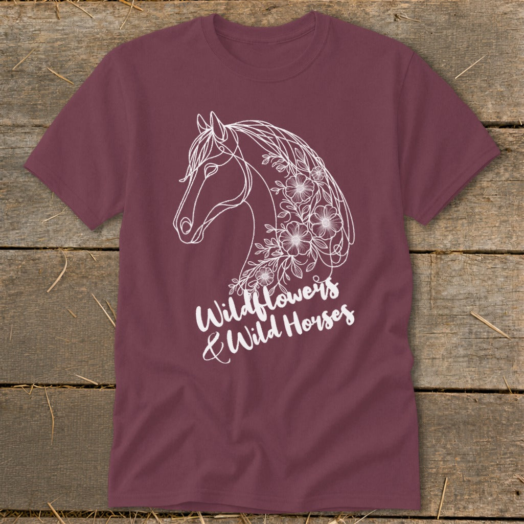 Maroon t-shirt with white line art of a horse head intertwined with wildflowers.