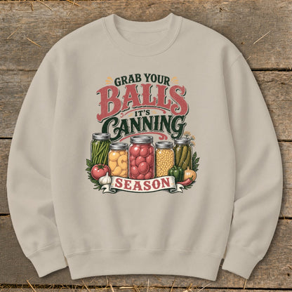 Graphic on sweatshirt with jars of preserves and "Grab your Balls It's Canning Season."