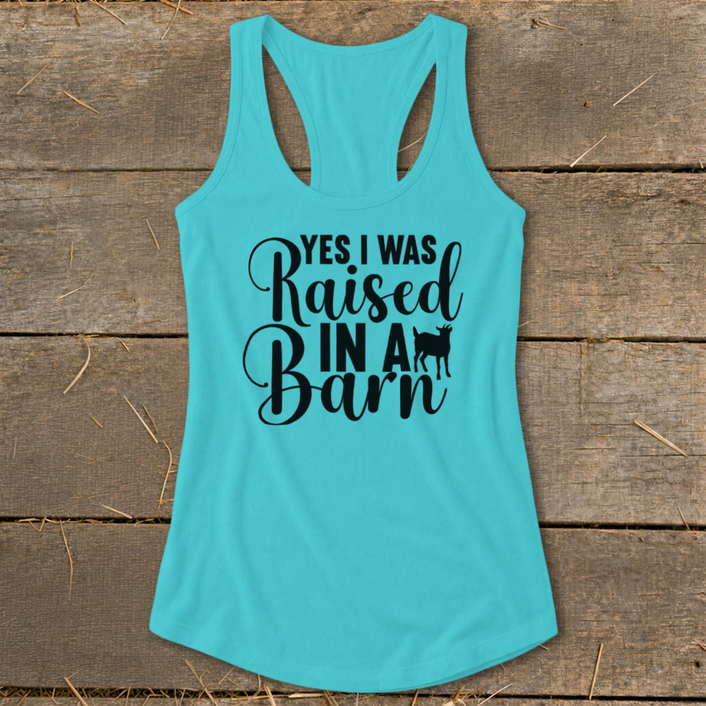 Turquoise tank top with black text "YES I WAS Raised IN A Barn" and a goat silhouette.