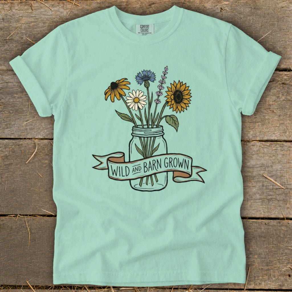 Mint t-shirt with mason jar of wildflowers and "Wild and Barn Grown" banner.