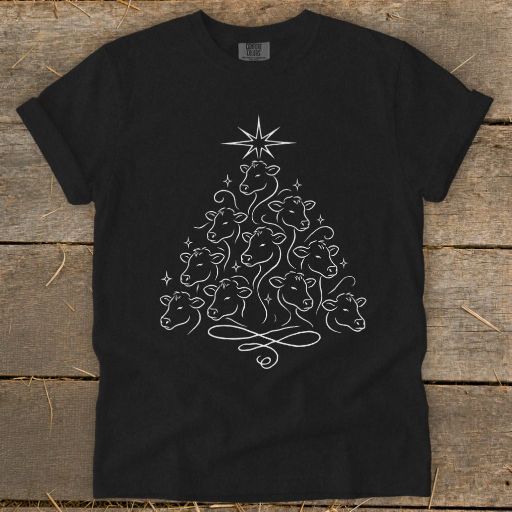 Black t-shirt with white line art of cows forming a Christmas tree and a star.