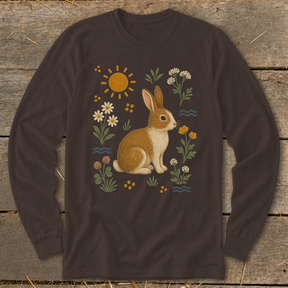 Brown long-sleeve shirt with a whimsical bunny illustration surrounded by flowers and sun.