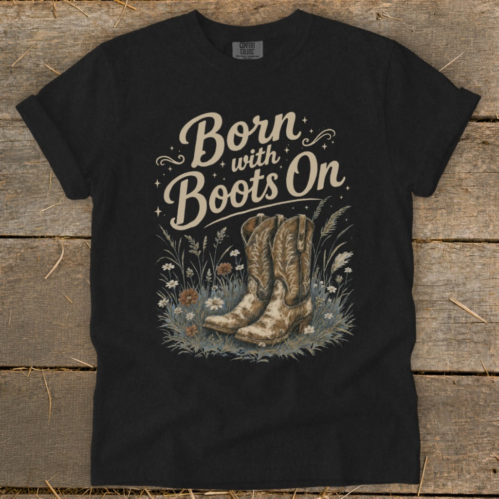 Black t-shirt with "Born with Boots On" text and cowboy boots in wildflowers.