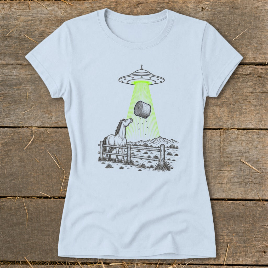 UFO abducting a hay bale over a curious horse in a fenced pasture.