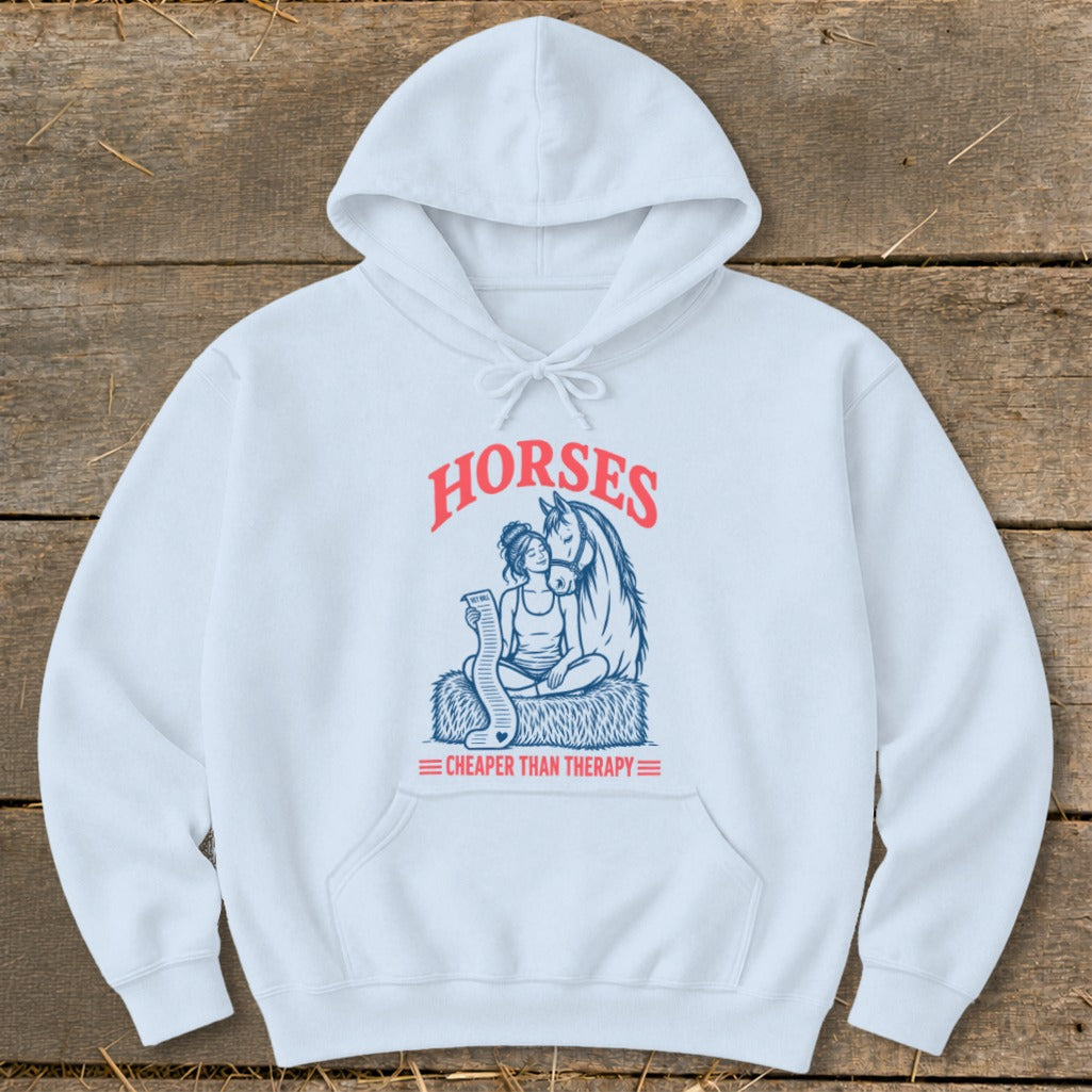 White hoodie with graphic of woman and horse, text "HORSES CHEAPER THAN THERAPY".