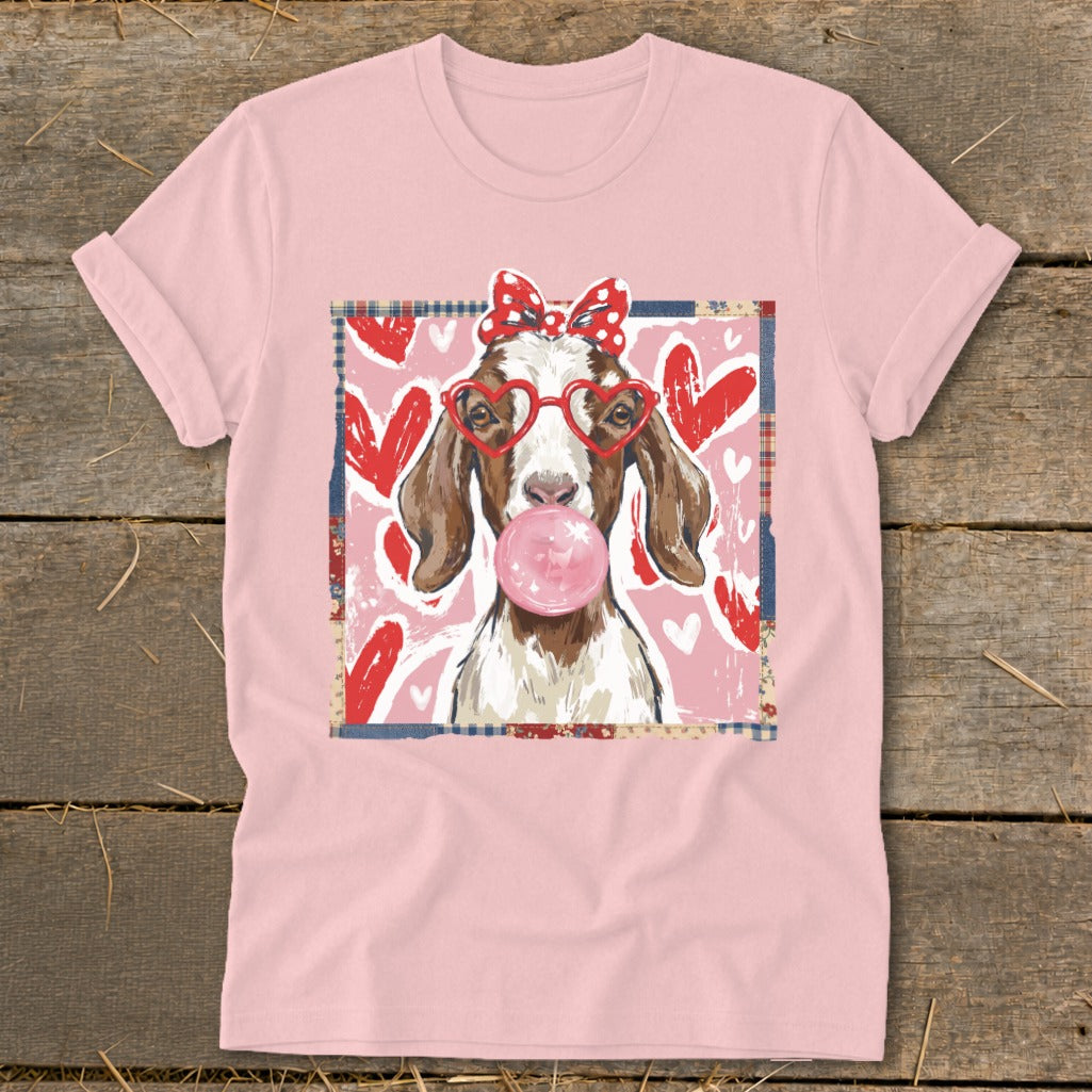 Goat with heart glasses and polka dot bow blows bubblegum in front of hearts.