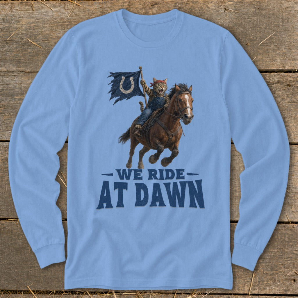 Cat in denim overalls rides horse holding flag with horseshoe, text "WE RIDE AT DAWN".