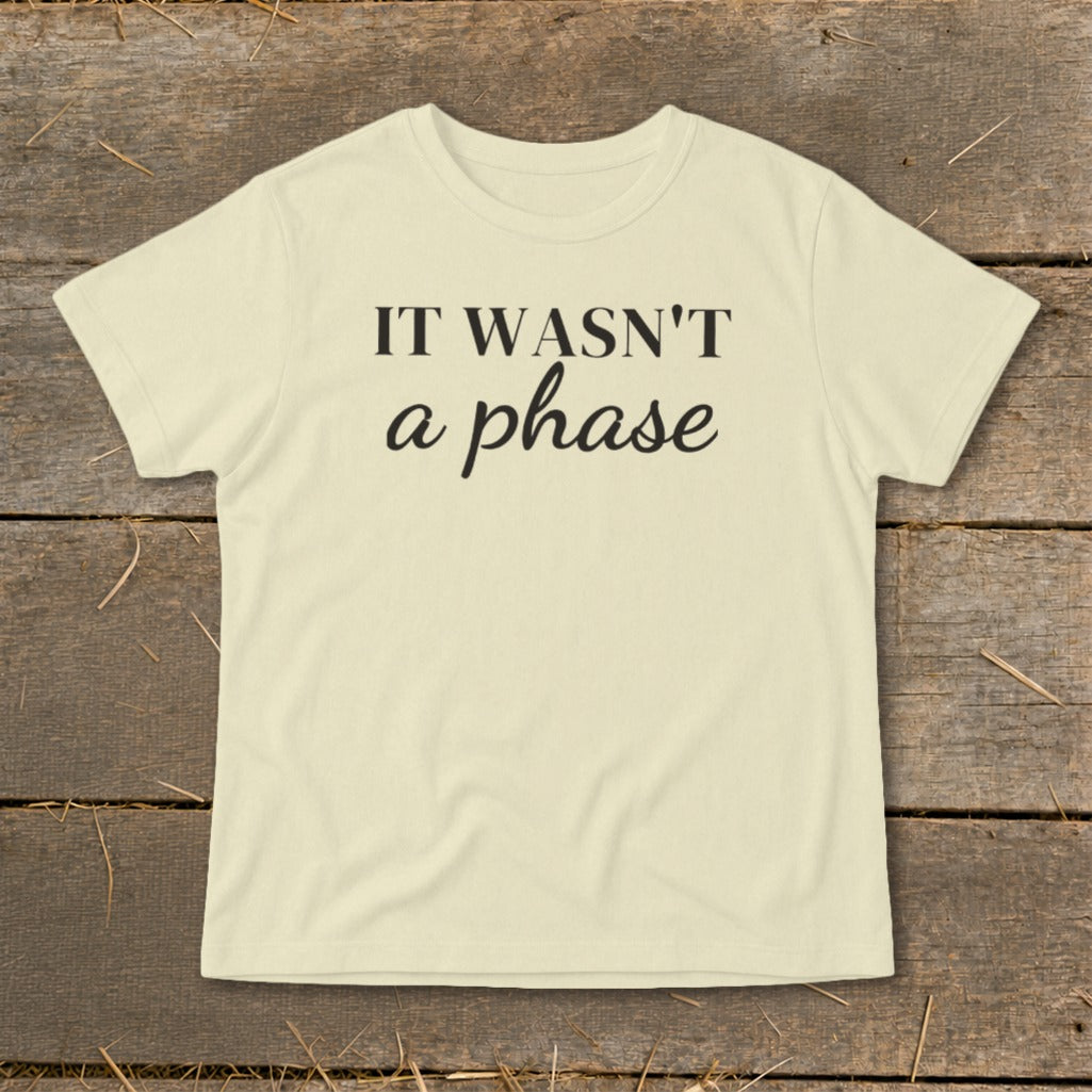 Light yellow t-shirt with black text "IT WASN'T a phase".