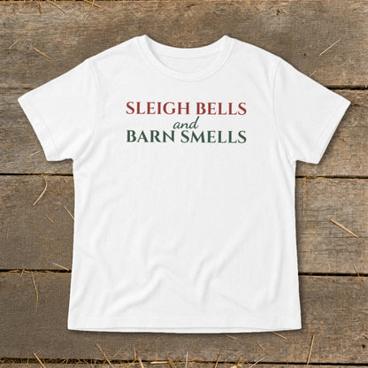 White t-shirt with red and green text reading "SLEIGH BELLS and BARN SMELLS".